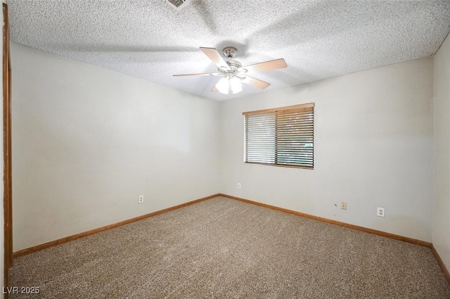 empty room with a textured ceiling, baseboards, ceiling fan, and carpet floors