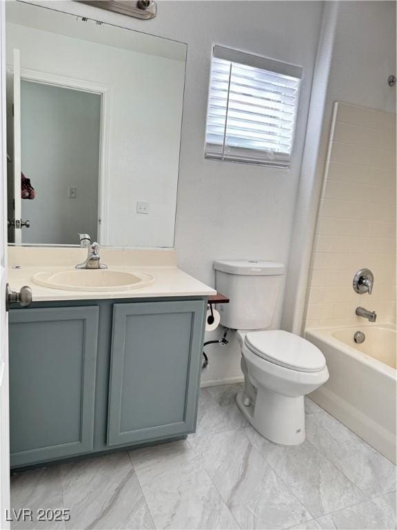 bathroom featuring toilet, vanity, and  shower combination