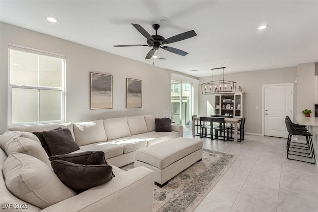 living area with recessed lighting, ceiling fan with notable chandelier, baseboards, and visible vents