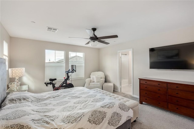 bedroom featuring visible vents, light carpet, connected bathroom, and a ceiling fan