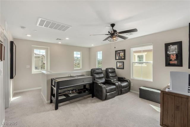 interior space featuring visible vents, baseboards, light colored carpet, and a healthy amount of sunlight