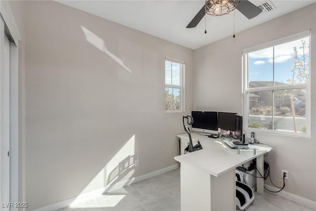 office area featuring light tile patterned floors, visible vents, baseboards, and a ceiling fan