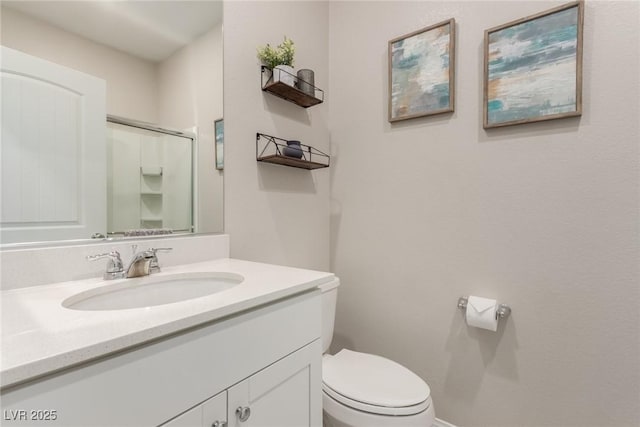 bathroom with an enclosed shower, toilet, and vanity