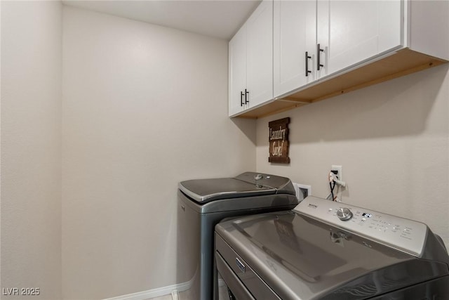 washroom with baseboards, cabinet space, and independent washer and dryer