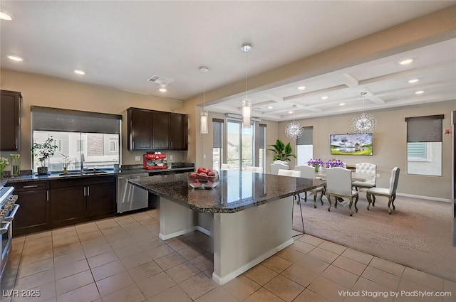 kitchen with a sink, coffered ceiling, appliances with stainless steel finishes, light colored carpet, and dark brown cabinets