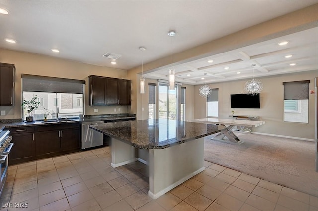 kitchen featuring light carpet, a sink, open floor plan, stainless steel appliances, and dark brown cabinetry