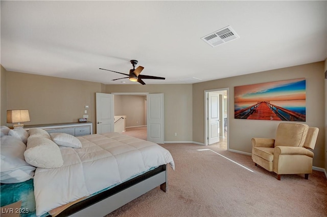 bedroom featuring light carpet, visible vents, a ceiling fan, and baseboards