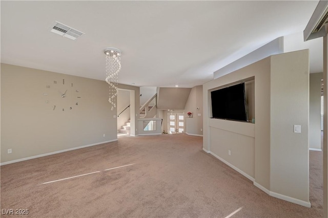 unfurnished living room featuring visible vents, baseboards, a chandelier, stairs, and carpet flooring