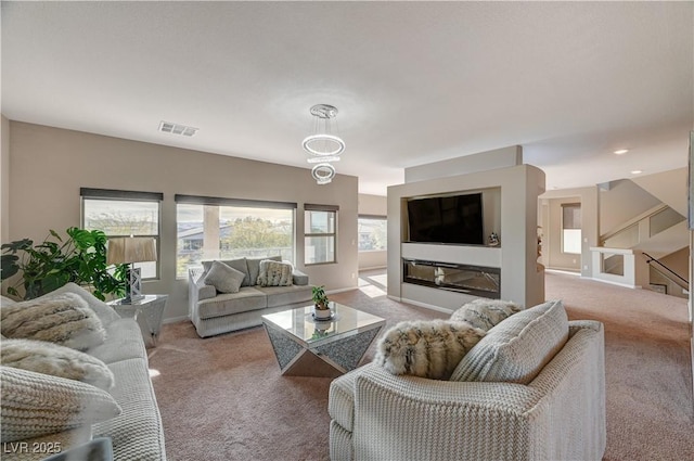 carpeted living room with baseboards and visible vents