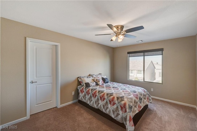 carpeted bedroom featuring visible vents, a ceiling fan, and baseboards