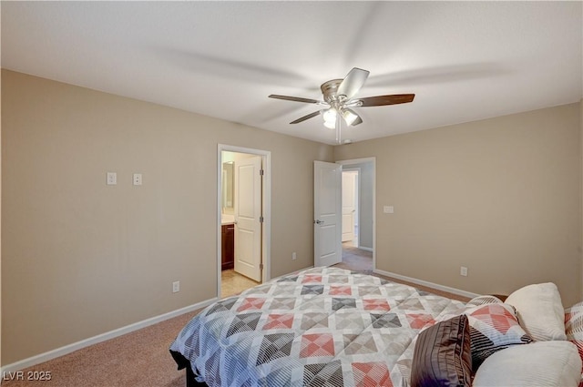 bedroom with light carpet, ceiling fan, ensuite bath, and baseboards