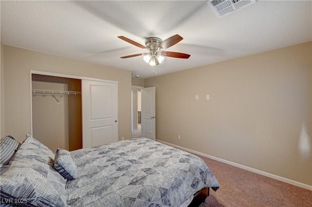 bedroom with visible vents, a closet, carpet floors, baseboards, and ceiling fan