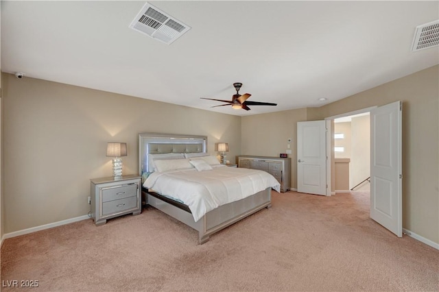 bedroom featuring visible vents, light colored carpet, and baseboards