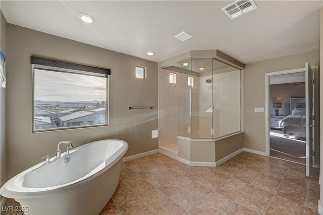 bathroom featuring visible vents, a healthy amount of sunlight, a stall shower, and a freestanding bath