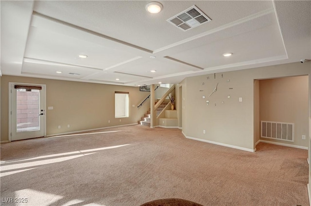 empty room with stairway, baseboards, visible vents, and light carpet