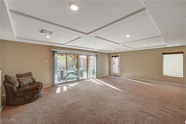 unfurnished living room with visible vents, carpet flooring, and baseboards