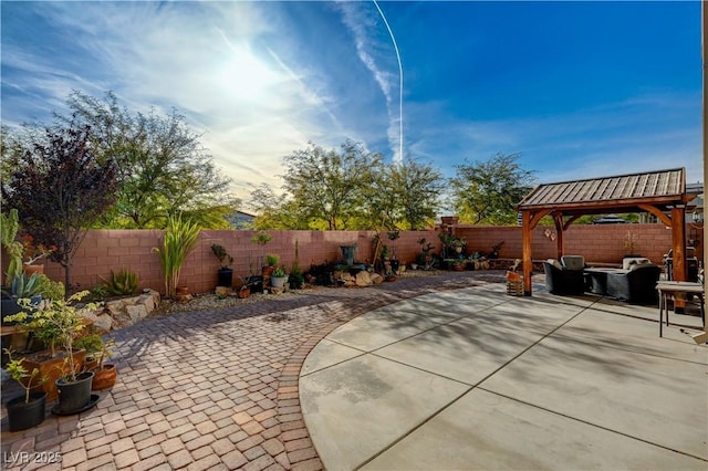 view of patio featuring a gazebo and a fenced backyard