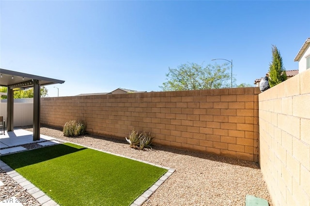 view of yard with a patio area and a fenced backyard