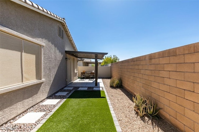 view of yard featuring a patio and a fenced backyard