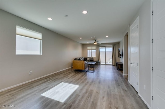 unfurnished living room with recessed lighting, wood finished floors, baseboards, and ceiling fan