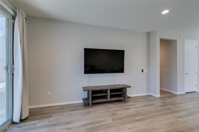 unfurnished living room featuring light wood finished floors, recessed lighting, and baseboards