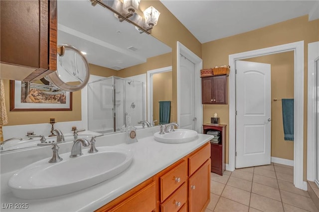 full bath featuring a sink, double vanity, a stall shower, and tile patterned floors