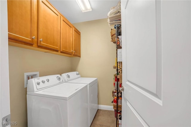 laundry room with cabinet space, washing machine and dryer, baseboards, and light tile patterned flooring