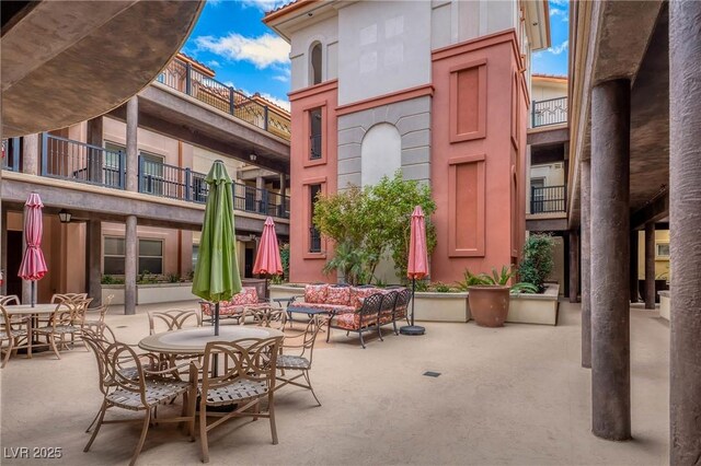 64 Strada Principale Unit 307, Henderson, NV 89011 - view of patio / terrace with outdoor dining area, a balcony, and an outdoor living space