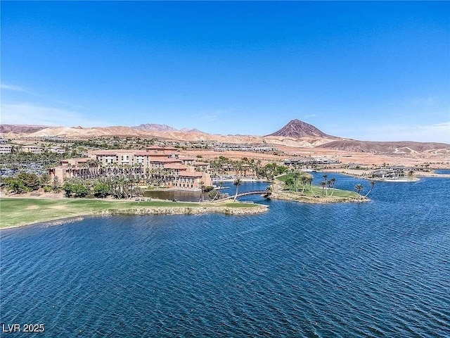 drone / aerial view featuring a water and mountain view