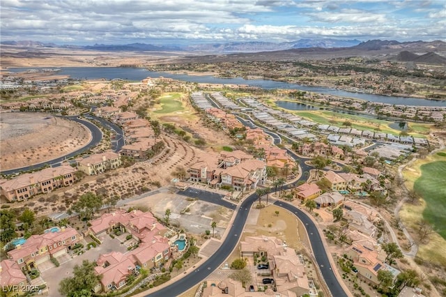 drone / aerial view with a residential view and a water and mountain view