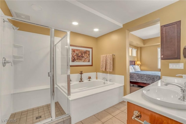 bathroom featuring tile patterned floors, a stall shower, a sink, connected bathroom, and a bath