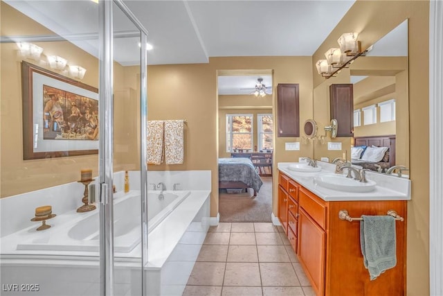 ensuite bathroom featuring a sink, connected bathroom, a garden tub, and a ceiling fan