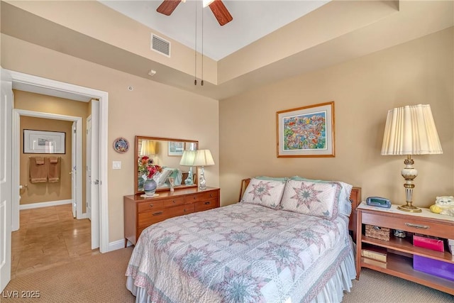 carpeted bedroom featuring visible vents, baseboards, and a ceiling fan