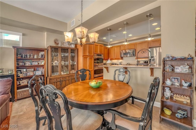 dining space featuring visible vents, recessed lighting, and an inviting chandelier