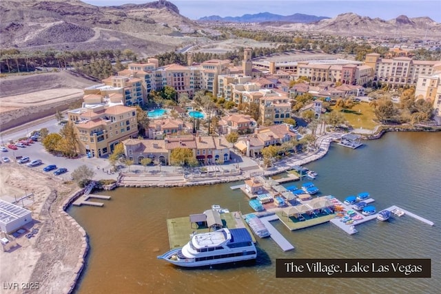 birds eye view of property featuring a water and mountain view