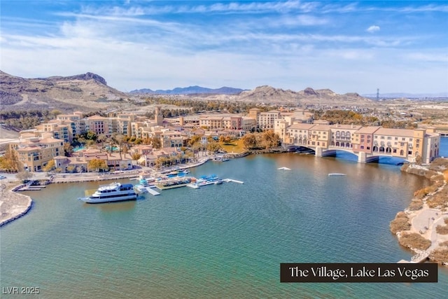 aerial view featuring a water and mountain view