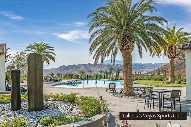 pool with a mountain view and a patio area