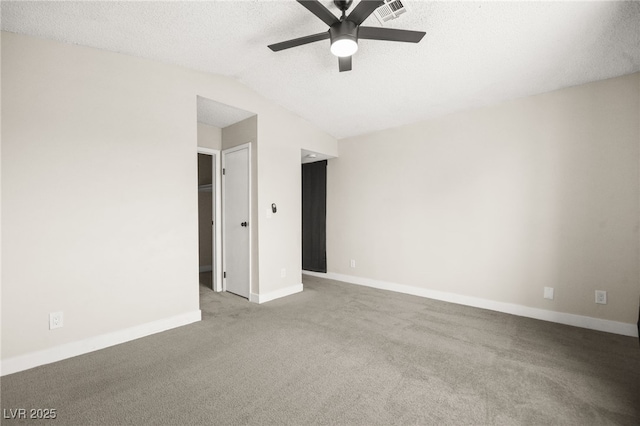 unfurnished room featuring lofted ceiling, a ceiling fan, visible vents, and baseboards