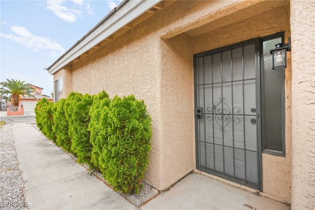 doorway to property with stucco siding