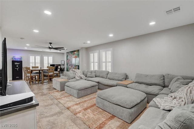 living area with recessed lighting, visible vents, and a healthy amount of sunlight