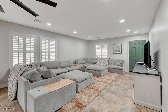 living area with recessed lighting, visible vents, baseboards, and ceiling fan