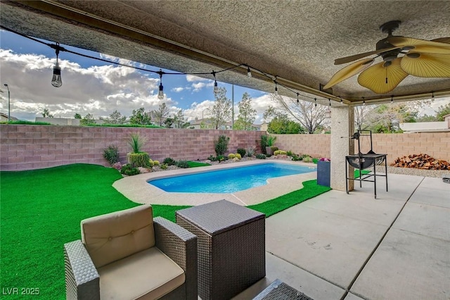 view of pool with a fenced in pool, a patio, a fenced backyard, and a ceiling fan