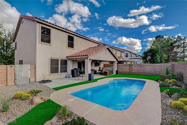 view of swimming pool featuring a patio area, a fenced in pool, a fenced backyard, and an outdoor living space