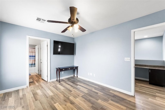 unfurnished living room featuring light wood-type flooring, baseboards, visible vents, and ceiling fan