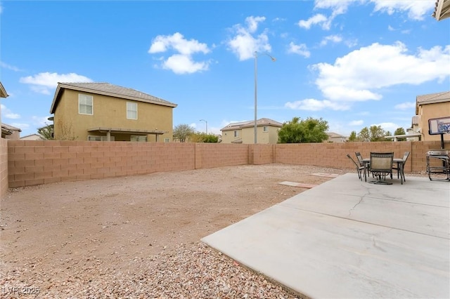 view of yard featuring a fenced backyard, a patio, and outdoor dining space