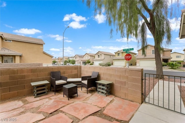 view of patio / terrace with an outdoor hangout area, a residential view, and fence