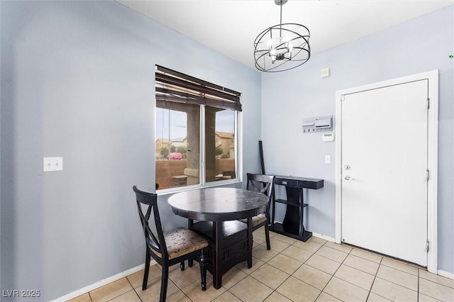 dining room with an inviting chandelier, light tile patterned floors, and baseboards