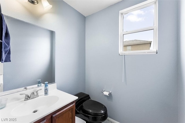 6429 Pronghorn Ridge Ave, Las Vegas, NV 89122 - half bathroom featuring toilet, vanity, and baseboards