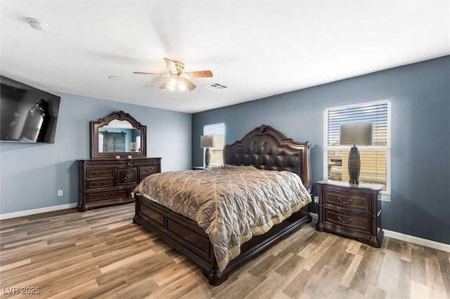 bedroom with visible vents, baseboards, and light wood-style floors