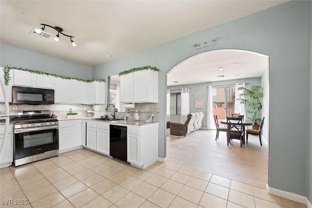 6429 Pronghorn Ridge Ave, Las Vegas, NV 89122 - kitchen featuring black appliances, arched walkways, a sink, and tasteful backsplash